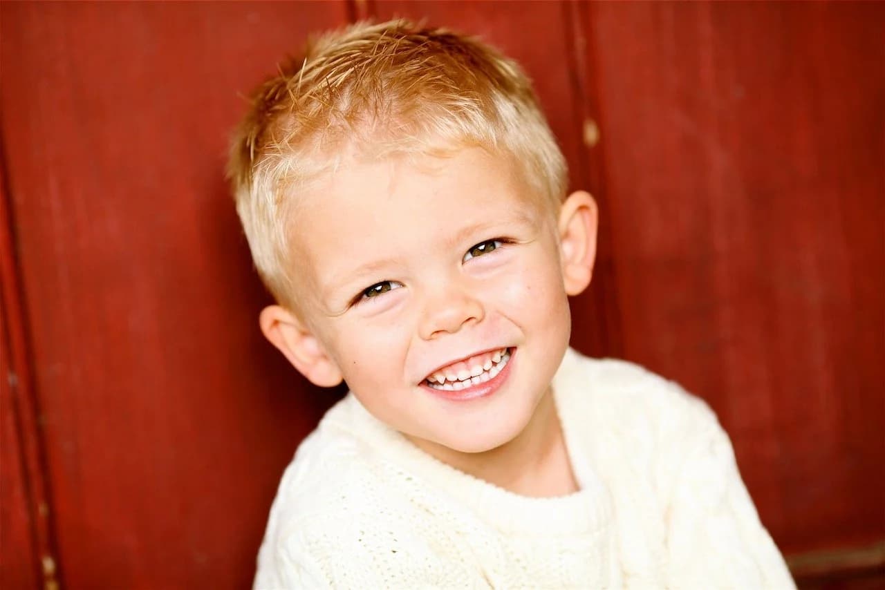 A young patient grinning ear to ear after his checkup